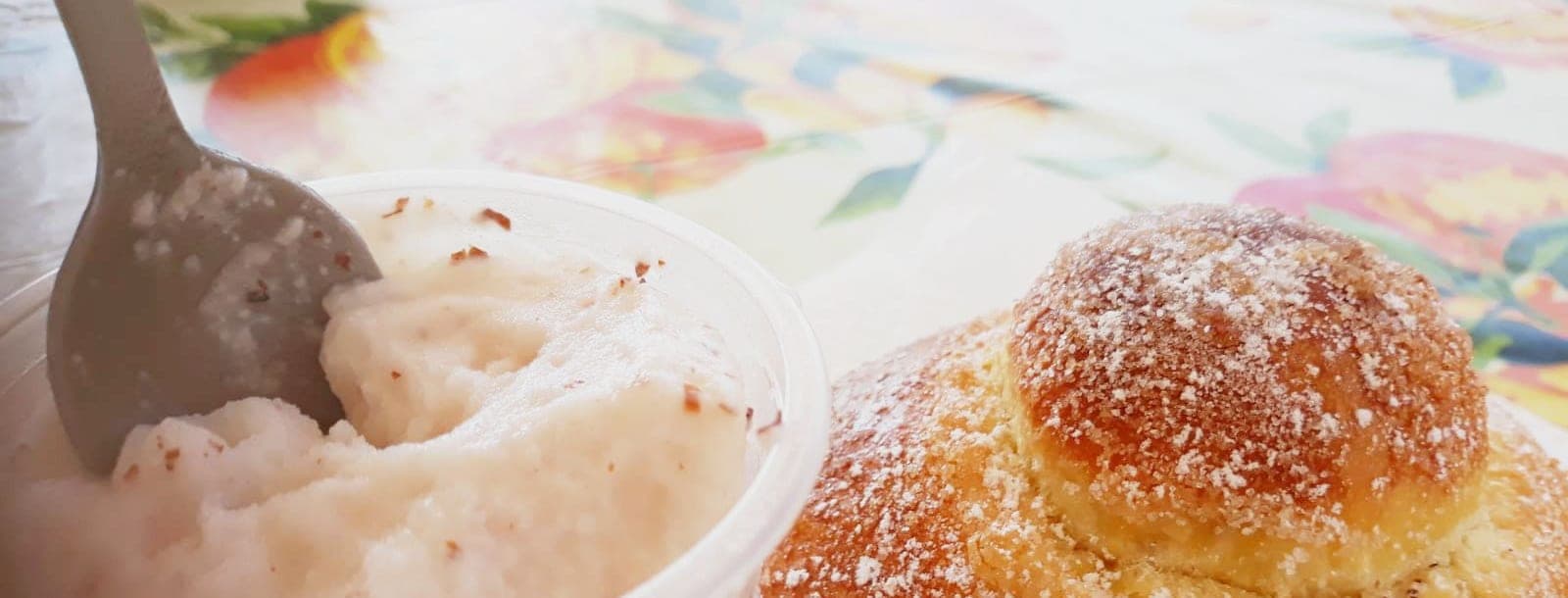 Almond granita and a brioche col tuppo on a table in Siracusa, the breakfast people here eat all summer