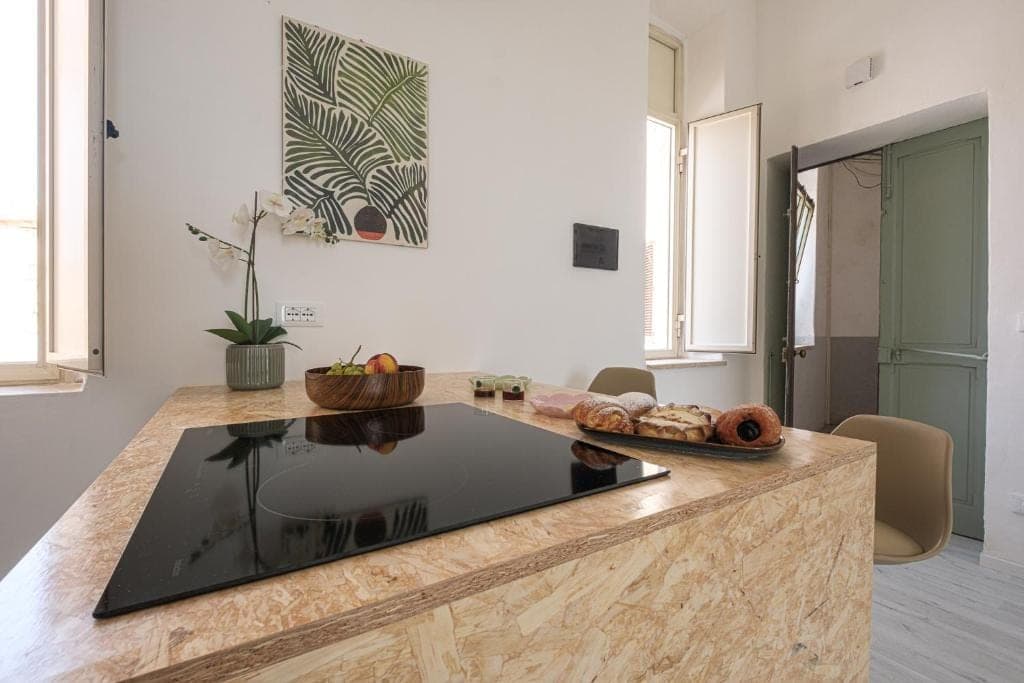 The kitchen island with its induction hob and Sicilian pastries just set out