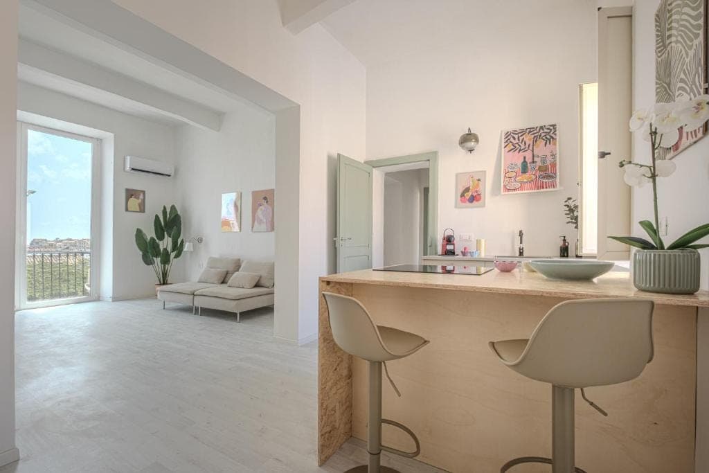The kitchen counter with its stools, seen from the living room